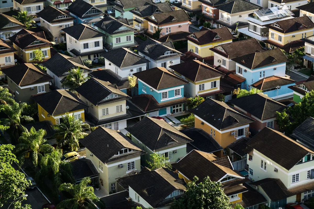 Aerial view of suburban rooftops, a capital city market splitting into fast and slow lanes