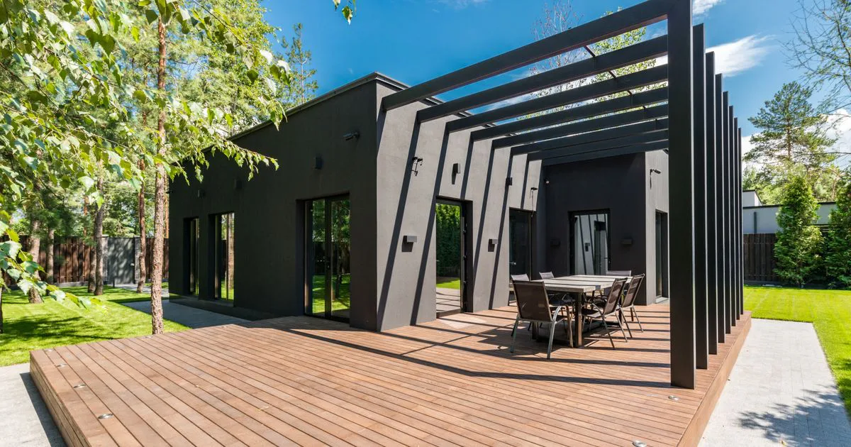 A sunlit north-facing backyard with a rear living area opening onto it