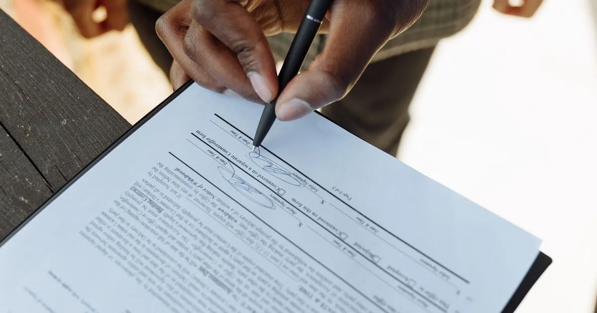 A property title and contract documents on a table, representing a planning certificate and Section 32 vendor statement