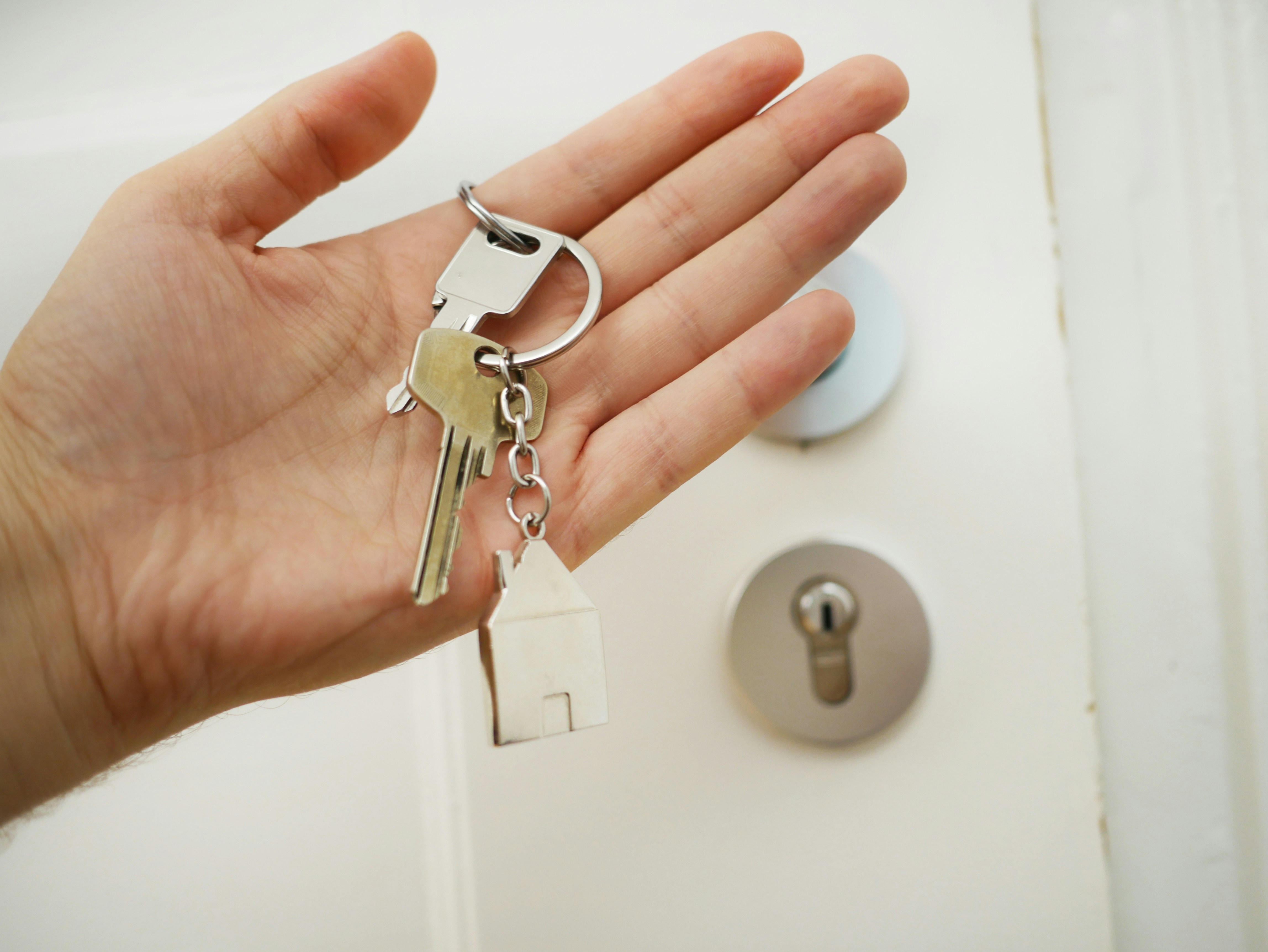 Home buyer receiving property keys after using Australian property insights, comparable sales data and valuation reports to buy confidently